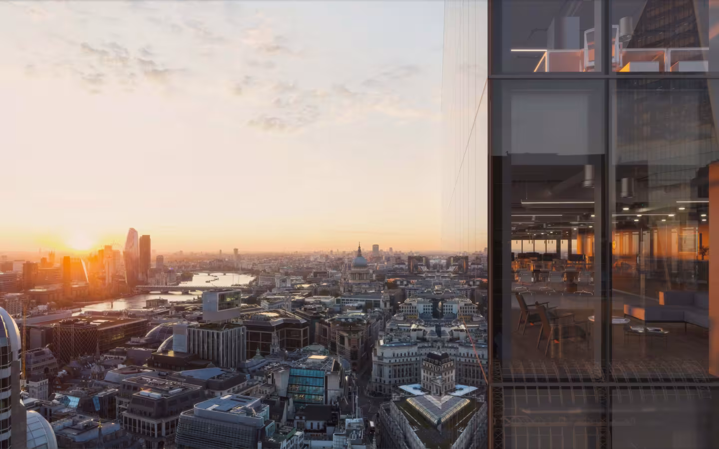 A BGRE office tower against a city skyline view at sunset featuring the River Thames and St Paul’s Cathedral framed by the glass façade and contemporary interiors of a high-rise office building.