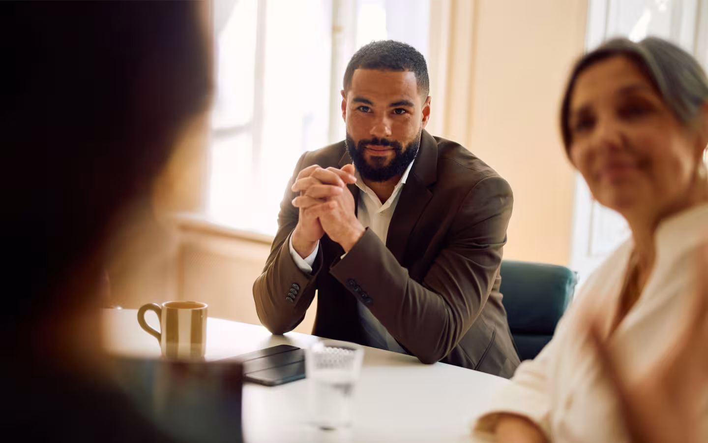 BGRE colleagues engaged in discussion around a meeting table.