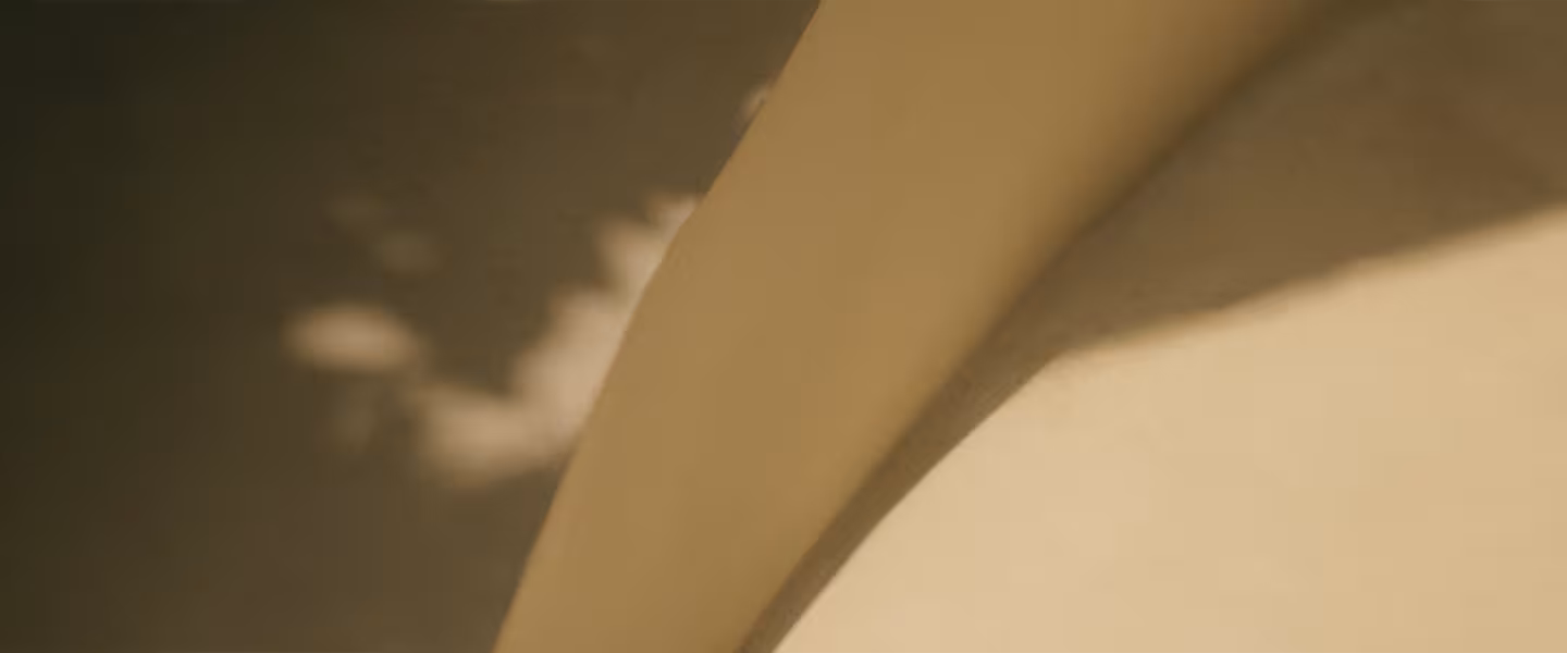Soft-focus architectural forms inspired by BGRE design, creating a textured backdrop for the contact section.