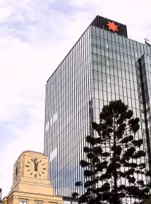 A BGRE office building with a glass exterior and surrounding city architecture.
