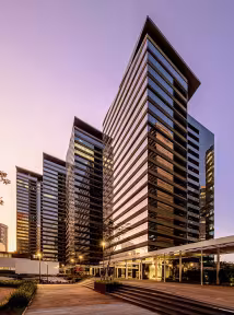 Exterior view of Parque da Cidade, a BGRE mixed-use Office development in São Paulo, Brazil, featuring modern office towers and landscaped public space illuminated at dusk.