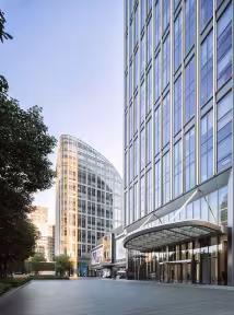 A BGRE commercial property featuring a glass entrance and surrounding office towers.